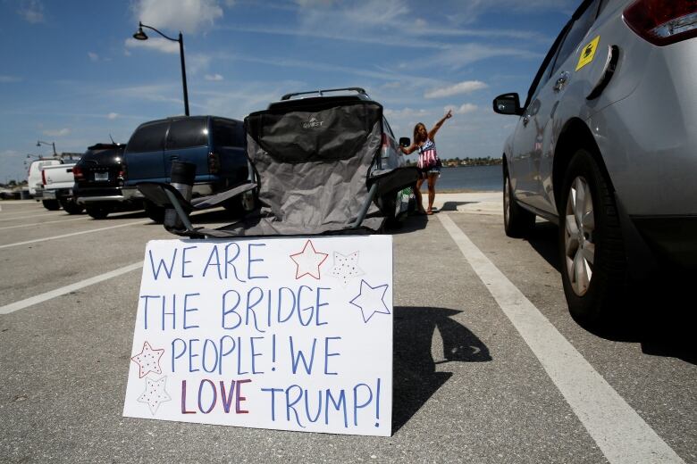 A sign supporting Donald Trump leans on a car near his home in Palm Beach, Florida.