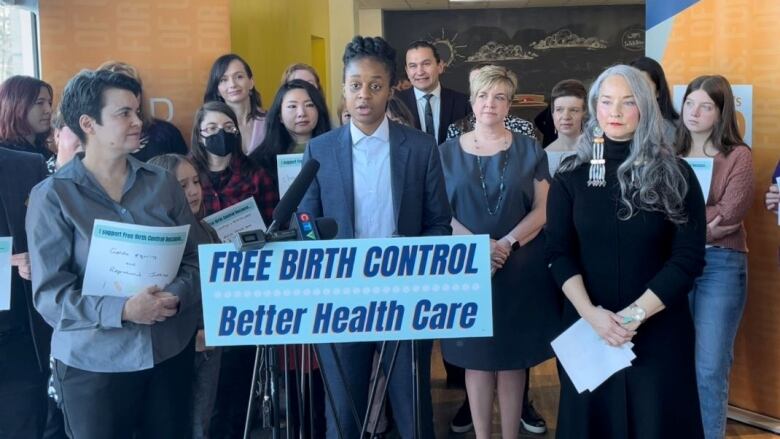 Several people stand around a podium.