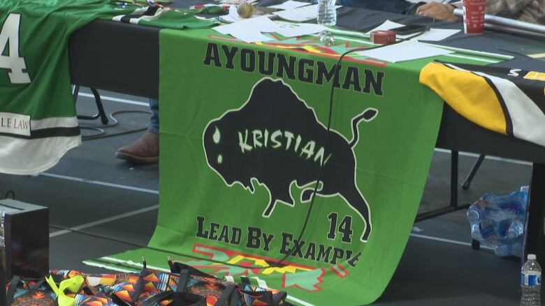 A green banner with the name 