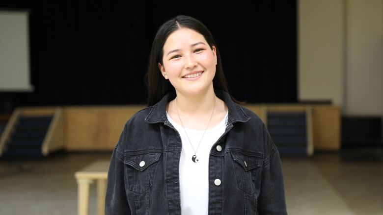 picture of Banin Arjmand standing in her school auditorium