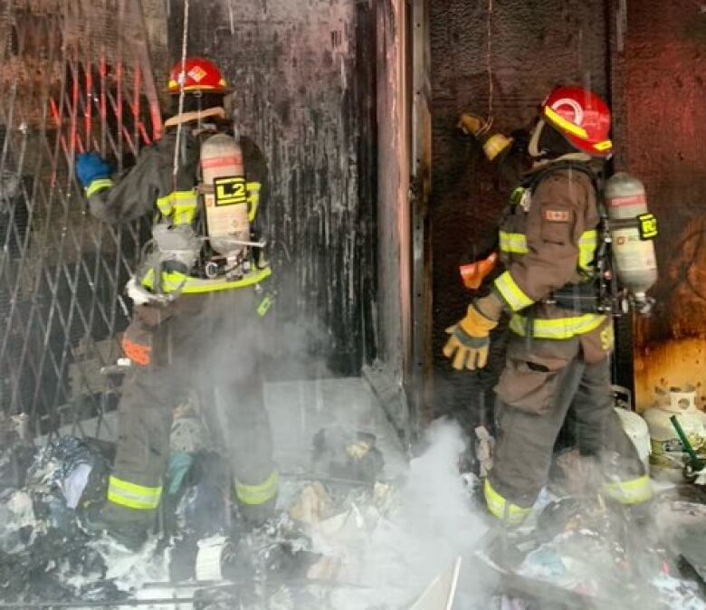 Firefighters attend to a fire at a building. 