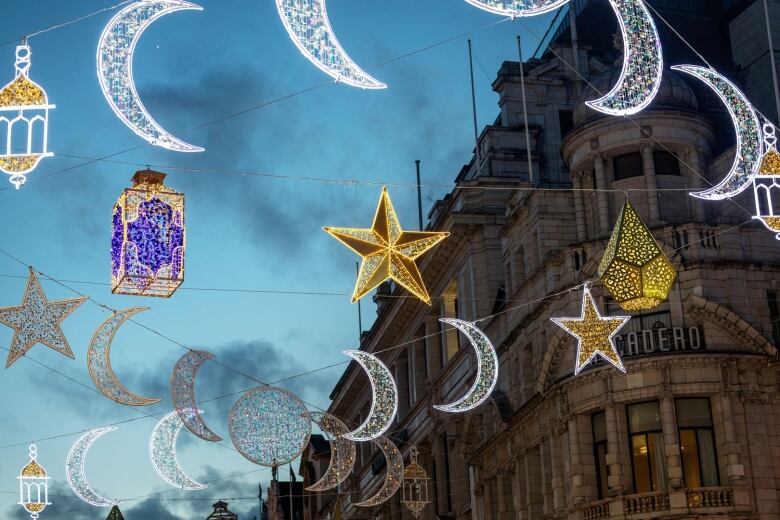 A string of light installations in the shapes of stars and crescent moons 