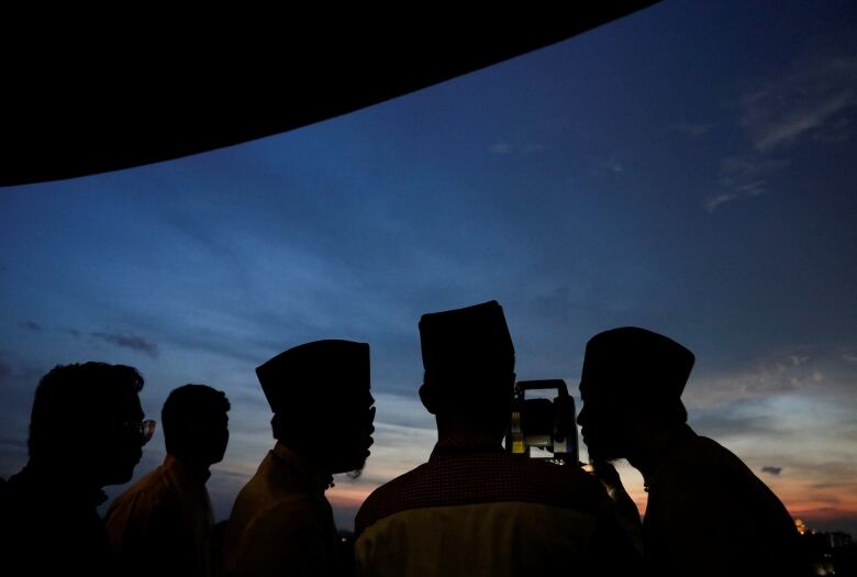 Officials use a theodolite to perform rukyah, the sighting of the new moon that signals the start of the holy month of Ramadan.