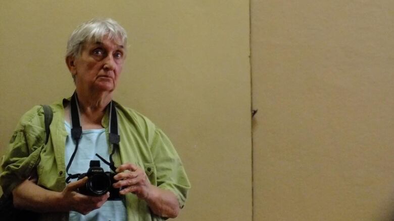 Older woman holding camera