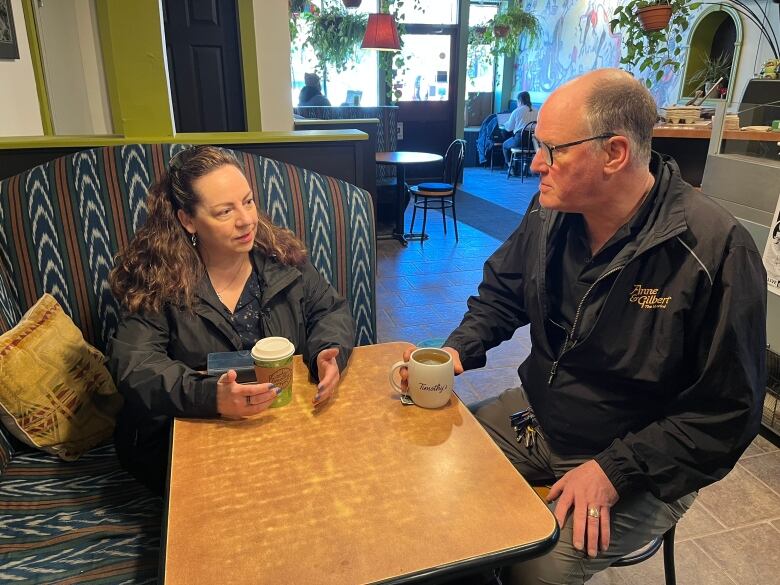 Woman and man have a cup of coffee at a cafe. 