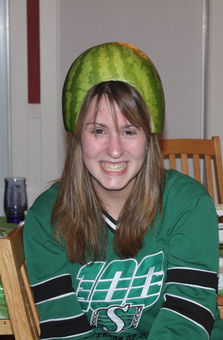 Picture of Emily Bryce in a Saskatchewan Roughriders shirt and watermelon hat.