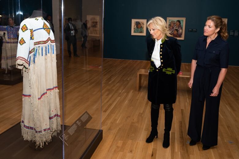 First lady Jill Biden and Sophie Gregoire Trudeau visit an art exhibit at the National Art Gallery.