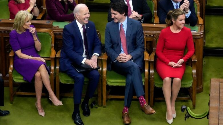 U.S. President Joe Biden and Prime Minister Justin Trudeau and their wives are pictured on the floor of the House of Commons.