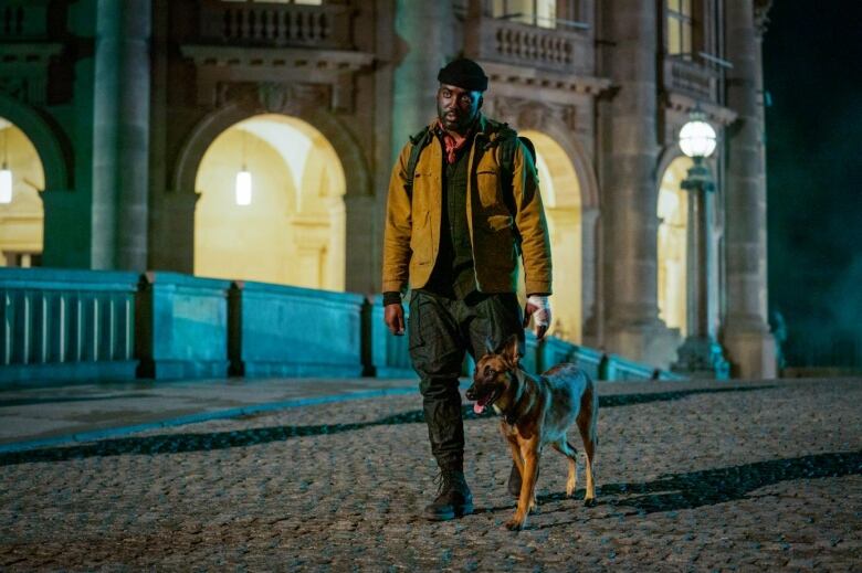 A man and his dog at night. 