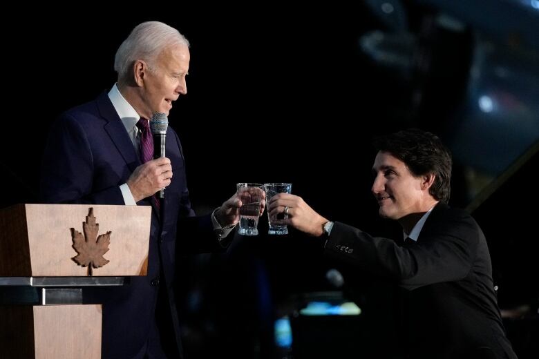 U.S. President Joe Biden toasts with Prime Minister Justin Trudeau during a gala dinner at the Canadian Aviation and Space Museum, in Ottawa.