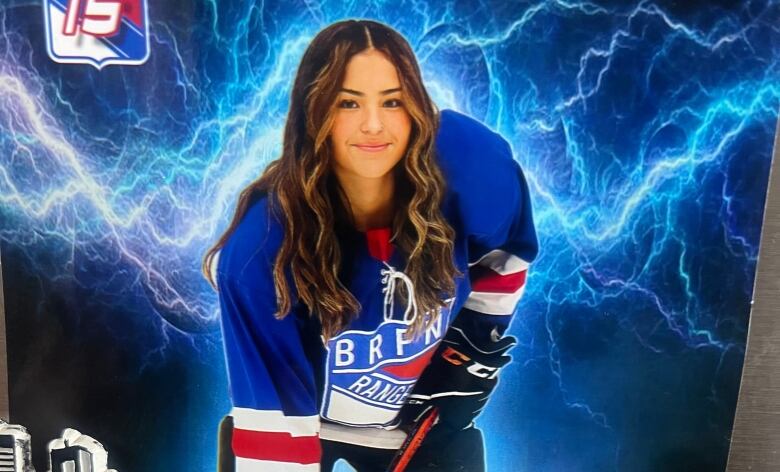 Girl in hockey equipment posing for a photo