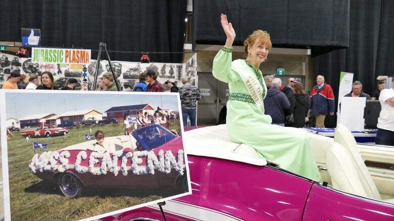 A lady in a green dress waves from a vehicle.