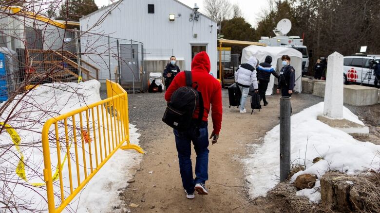 Olivier Nanfah crosses into Canada at Roxham Road, an unofficial crossing point from New York State to Quebec for asylum seekers, in Champlain, New York, U.S. March 25, 2023. REUTERS/Carlos Osorio