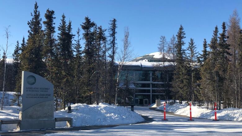 A sign in front of a building reads Legislative Assembly of the Northwest Territories.