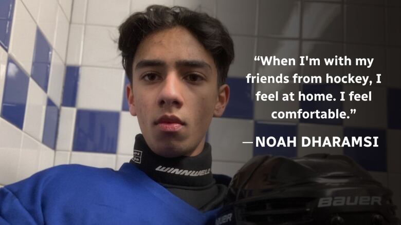 A boy wearing hockey gear looks into the camera. 