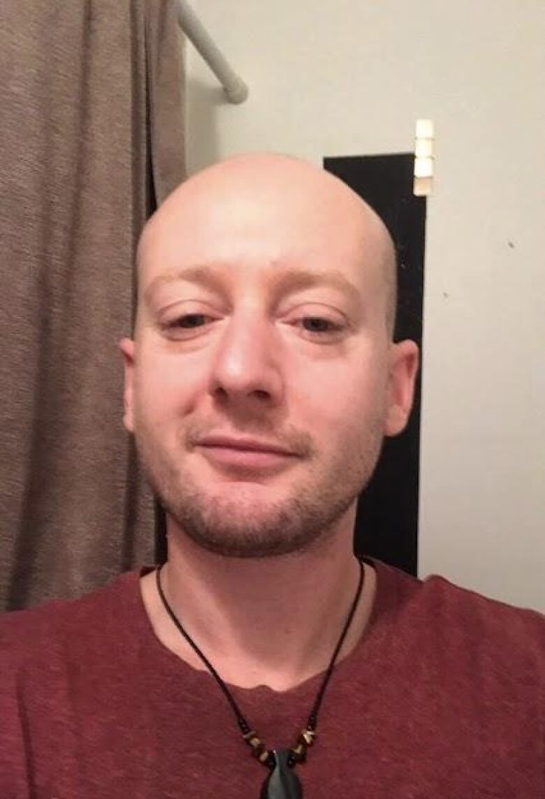 Selfie of a young man with no hair.