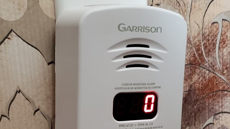 A carbon monoxide detector plugged into a wall.