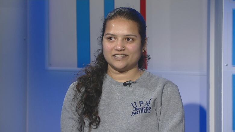 A university student sits inside the TV studio