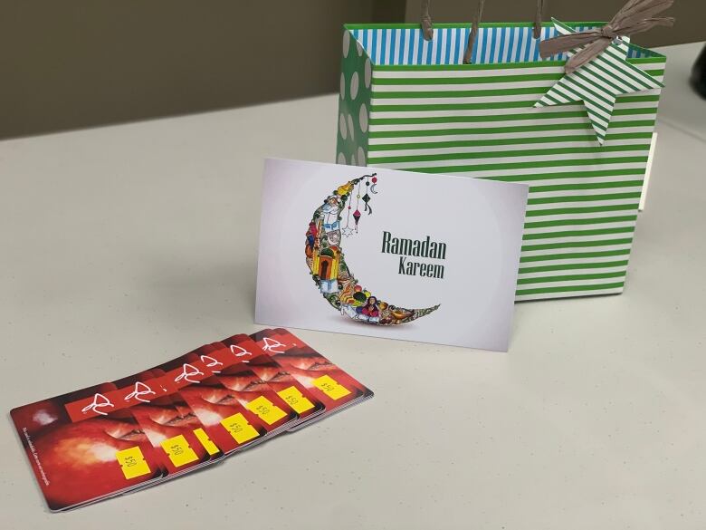 Pictured are grocery store gift cards, a Ramadan greeting card and a bag for the Ramadan hamper program.