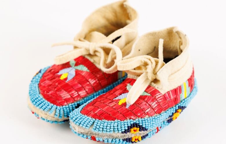 A pair of quilled, baby mocassins are pictured.