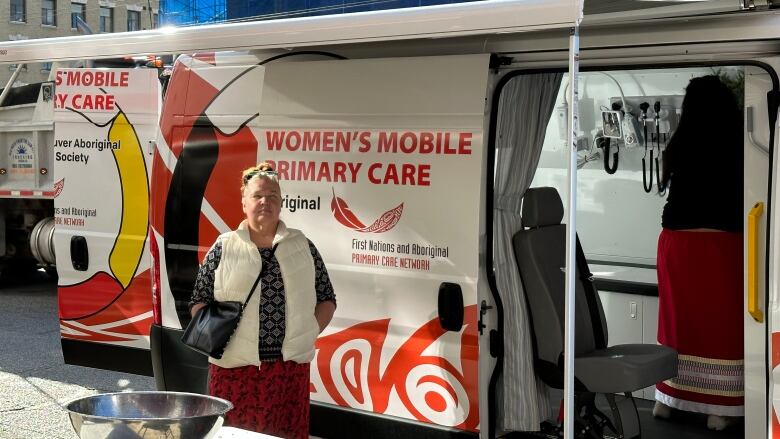 Ruby Ann-Harry is pictured in front of a new mobile health unit van in Vancouver on March 29, 2023. 