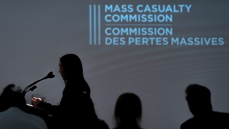 A woman speaks at a podium during the Mass Casualty Commission hearings.