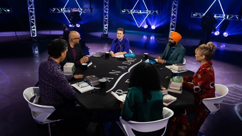 The cast of Canada Reads 2023 in studio for the final day of debates, from left to right: Michael Greyeyes, host Ali Hassan, Mattea Roach, Tasnim Geedi, Gurdeep Pandher and Keegan Connor Tracy.