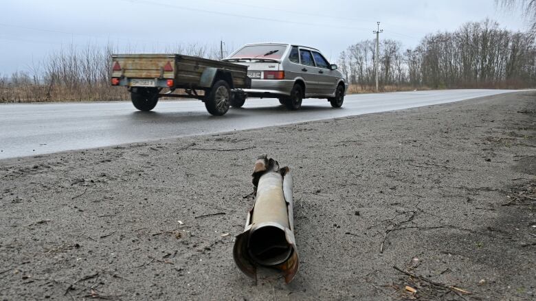 A missile fragment lies near a road.