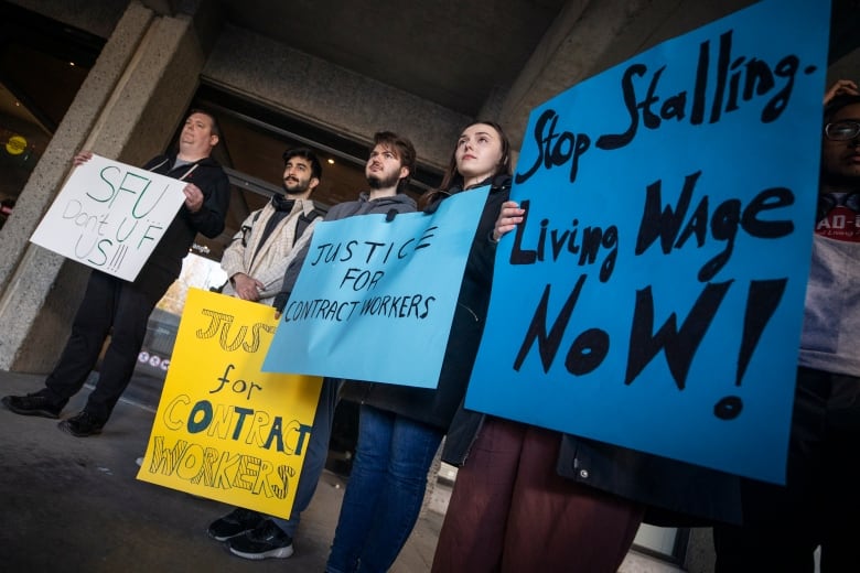 People are pictured during a demonstration in support of contract worker's rights.