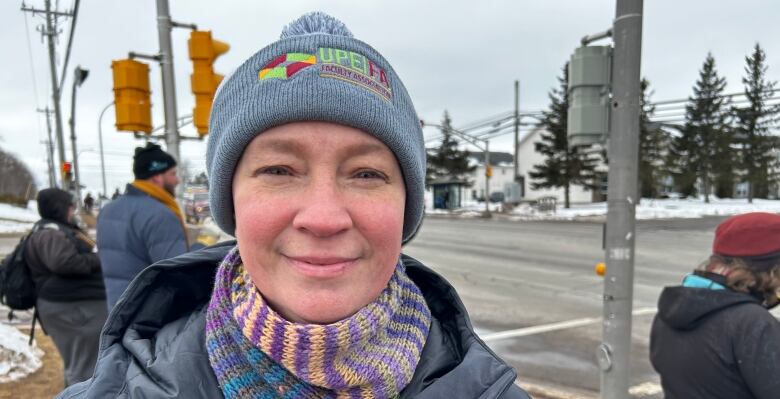 A woman wearing a UPEI Faculty Association beanie hat.