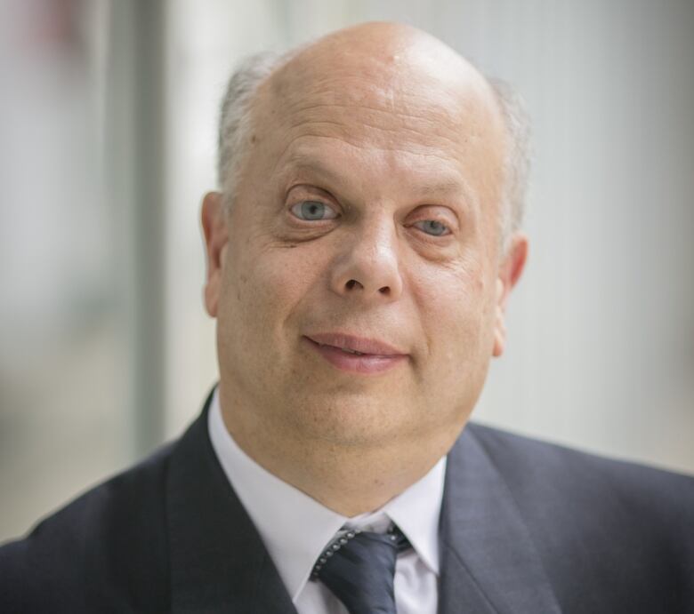 David Lepofsky in a black suit and blurred background