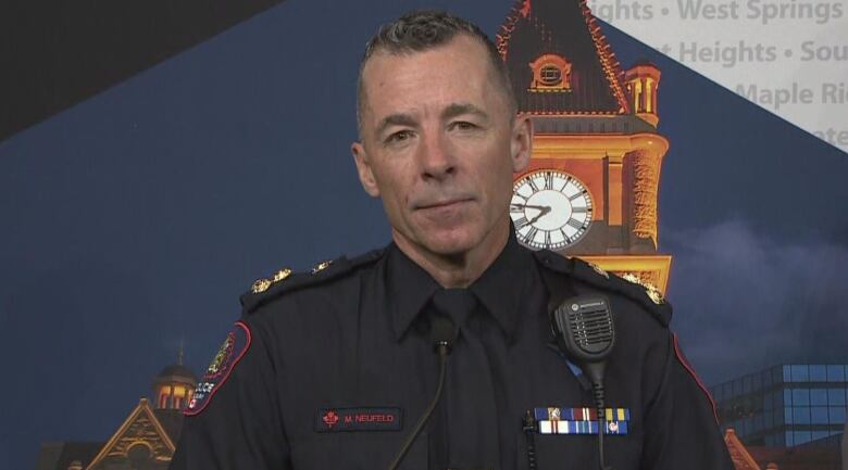 A police officer looks at the camera during a press conference.