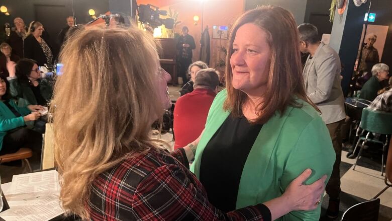 Karla Bernard is greeted by a supporter.