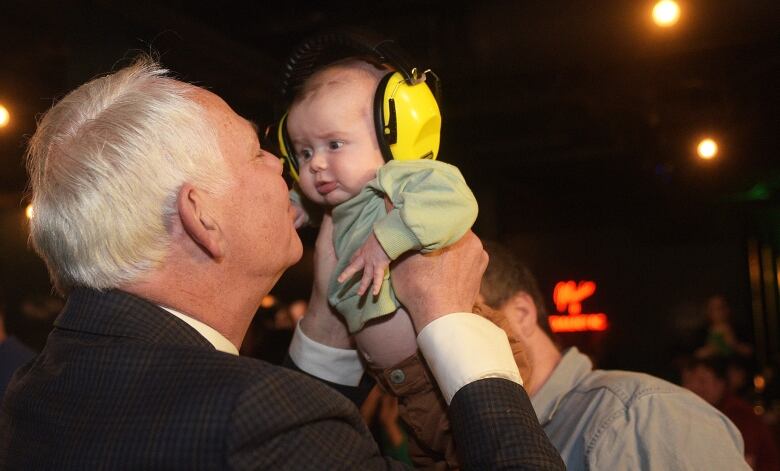 Peter Bevan Baker hugs his grandchild