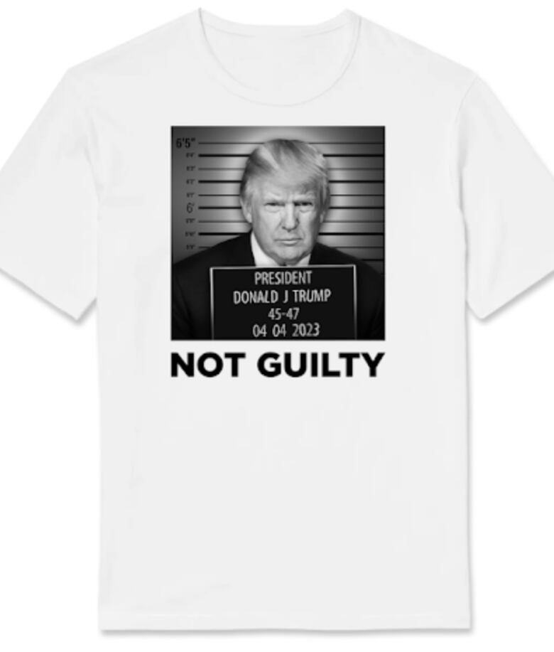 A white T-shirt with a false black and white mug shot of Donald Trump with the words 'Not Guilty' written on it. 