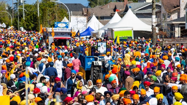 Harnaik Singh serves food during Vaisakhi parade in Surrey, British Columbia on Saturday, April 20, 2019.