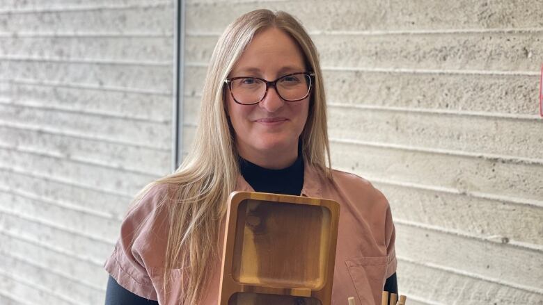 Professional organizer Celeste Imus holds some of the items she uses to help declutter spaces.