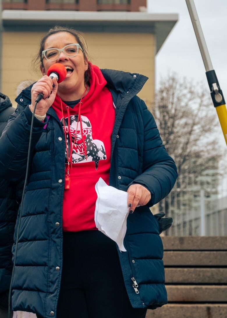 A woman speaks into a microphone. 