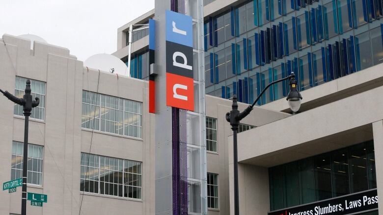 A sign with the logo of National Public Radio stands outside its headquarters in Washington, D.C.