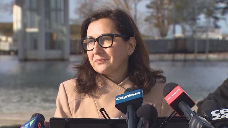 Ana Bailo stands at a podium at Ontario Place.