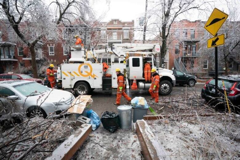 Men are at work in an icy street.