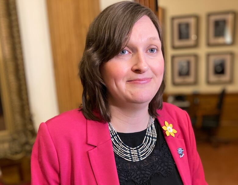 Megan Mitton smiles in the legislature. 