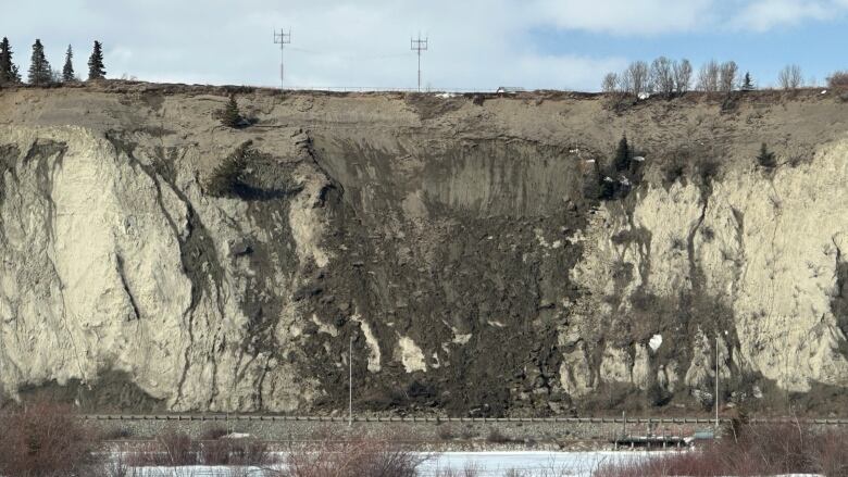 The picture shows a landslide near a road. 