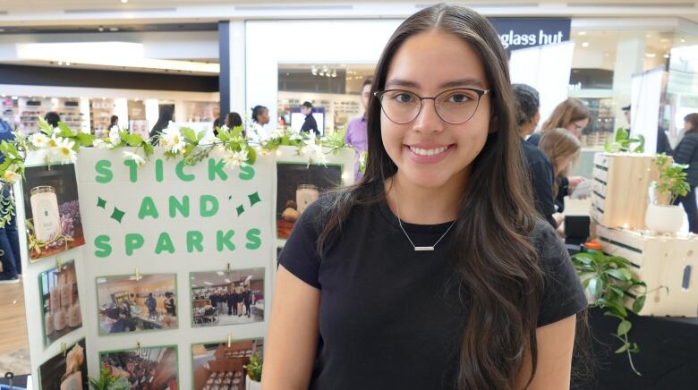 A young woman smiles toward the camera.