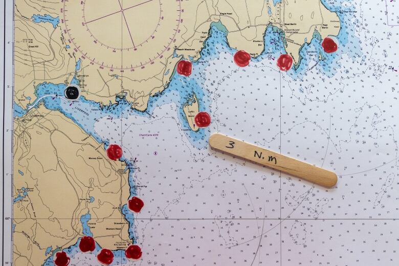 A map shows red dots that mark locations of surf spots and a black dot that shows the location of the expedition launch. 