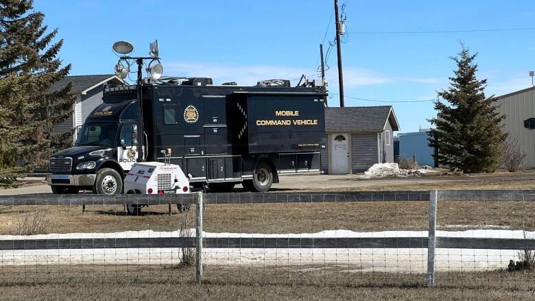 A police vehicle is parked on a yard.