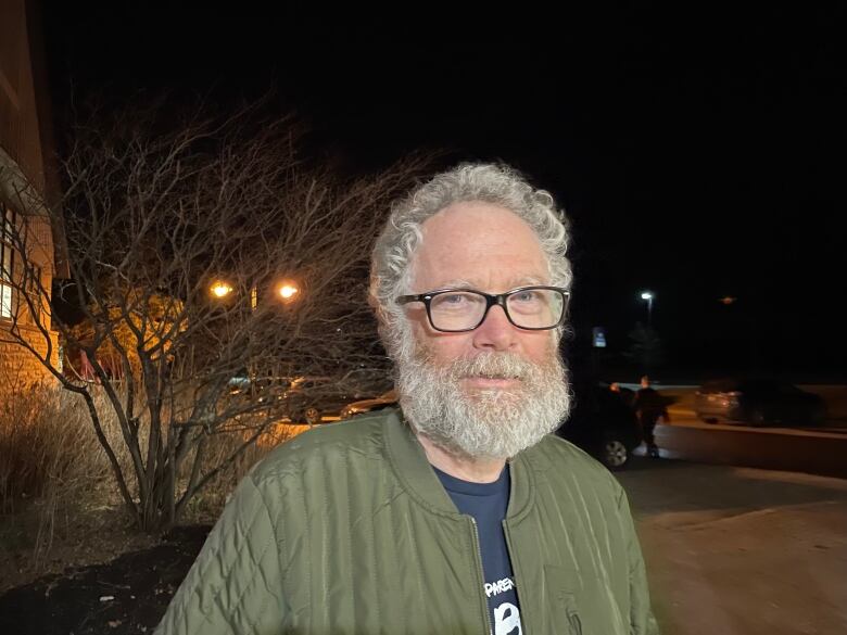 A man with a white beard and glasses.