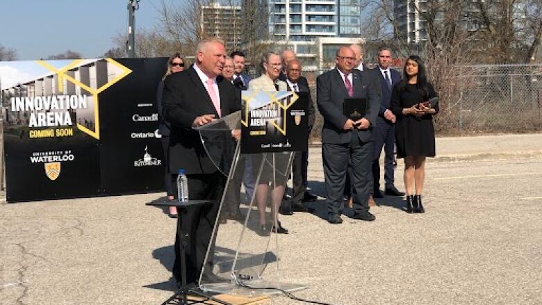 Premier Doug Ford stands at a construction site in Kitchener. 