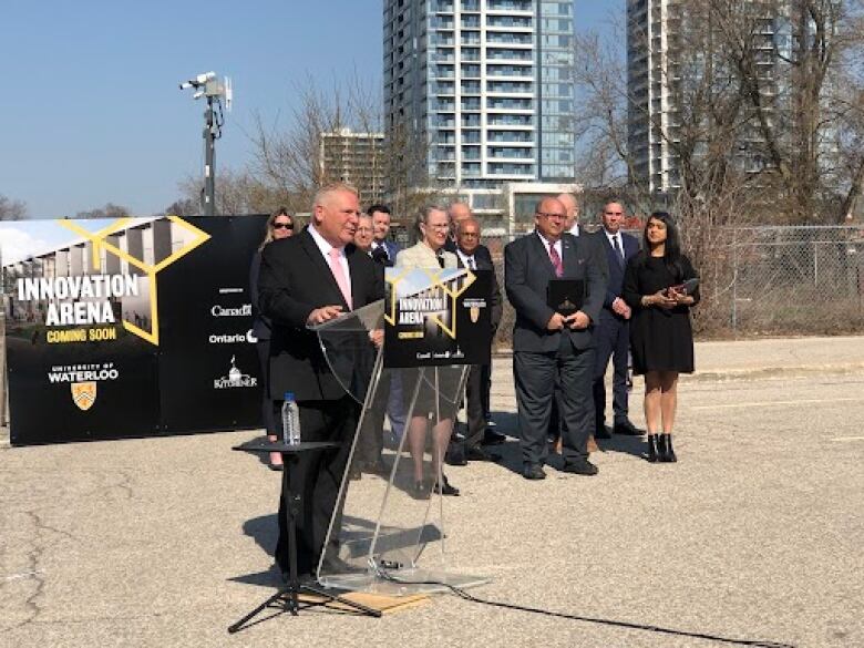 Premier Doug Ford stands at a construction site in Kitchener. 