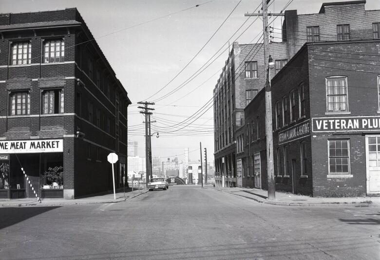 A black and white photo of an empty street. 